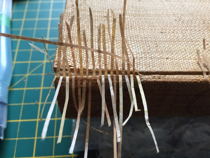In process conservation treatment creating a woven infill of thin strips of Japanese paper.