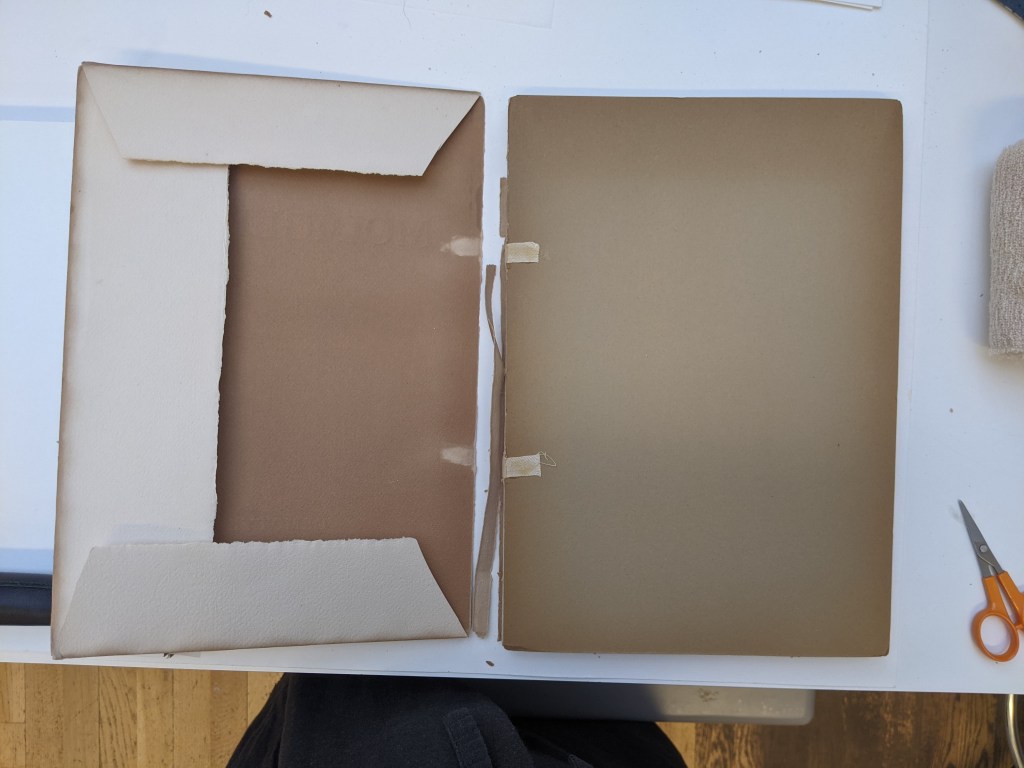 Image shows a book showing the front board and inside of the front dust jacket cover. The board is very brown and discoloured passing the discolouration over to the dust jacket