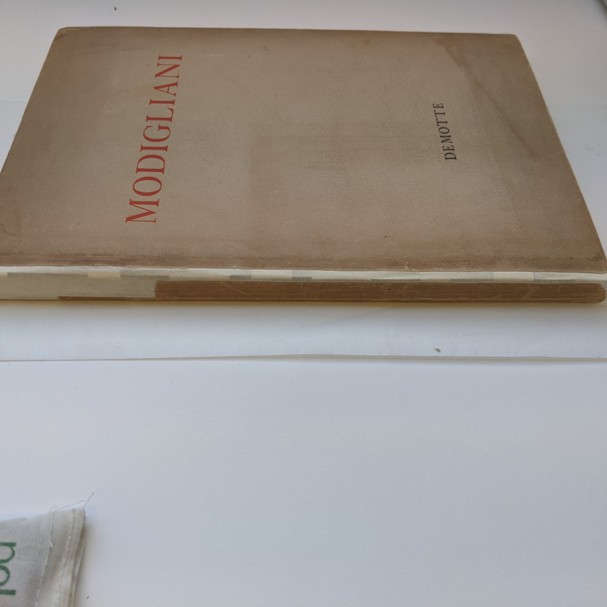 The dust jacket is now shown in place around the text block of the book.